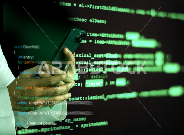 Hand image of a young Saudi Gulf working as a web developer, using programming languages, developing and building websites and electronic applications, programming codes to build smart phone applications