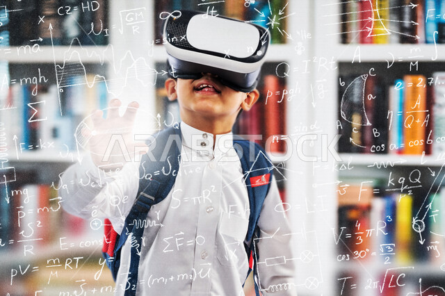 A Saudi Arabian Gulf student wearing school uniform and school bag using virtual reality glasses in front of a group of mathematical and scientific sciences using the 3D hologram feature, education in the Kingdom of Saudi Arabia