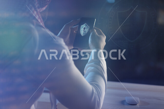 A Saudi Arabian Gulf man holding a mobile phone containing the logo of the smart electronic lock, the smart lock program, cyber security, risk management and information security.