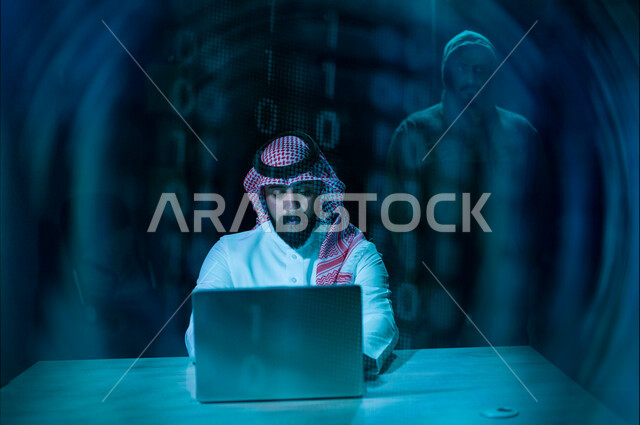 A Saudi Arabian Gulf businessman, working to protect his laptop from electronic attacks, a hacker working in the field of security penetration, the ability to penetrate device protection, electronic crimes
