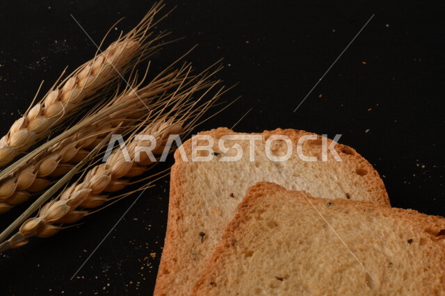 Image of crispy rusks on black background, close-up of freshly toasted baked goods, shaburah