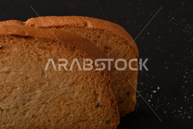 Image of crispy rusks on black background, close-up of freshly toasted baked goods, shaburah