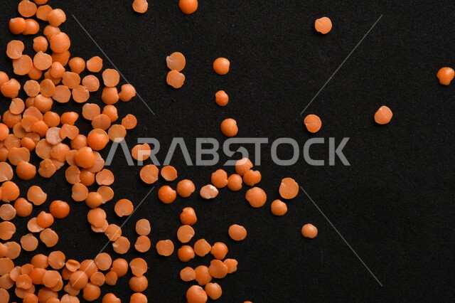 Close up of a bunch of red lentils on a black background, healthy food vegetable seeds, dry vegetable lentils