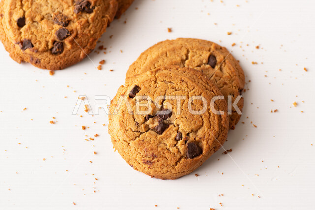 Hot chocolate chips on white background, light and crispy cookie chips with delicious dark chocolate pieces, cookies, chocolate chip cookies, fresh baked dessert
