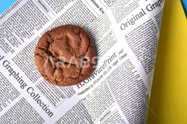 Image of hot chocolate chips on parchment paper, light and fluffy cookie sheets with delicious dark chocolate chunks, cookies, chocolate chip cookies, fresh baked desserts