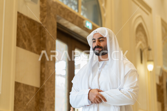 الركن الثاني من اركان الاسلام، التقرب إلى الله عن طريق القيام بالفرائض والعبادات، رجل عربي خليجي اماراتي يرتدي الكندورة والغترة البيضاء يقوم بأداء فريضة الصلاة على وقتها في المسجد، اداء الصلاوات في المساجد