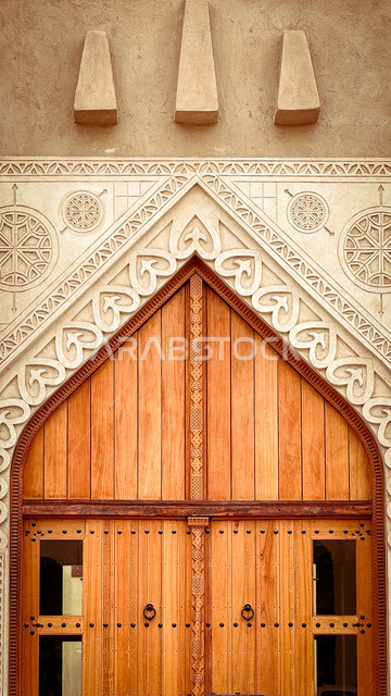 A large wooden gate in the Qaisariya Heritage Market in Al-Ahsa ...