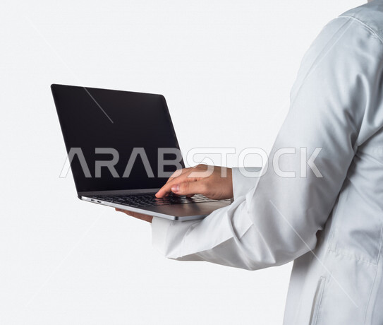 Portrait of a Saudi Gulf man holding a laptop in his hand, remote work, e-learning, using modern technical devices, white background