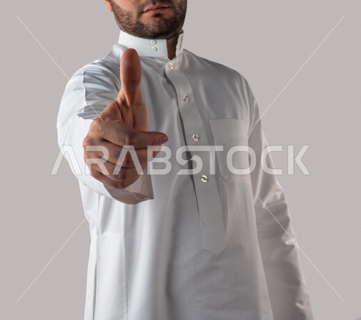 Portrait of a Saudi Gulf man in traditional Gulf dress making different hand gestures, thumbs up to like something, white background
