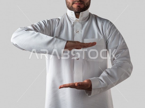 Portrait of a Saudi Arabian Gulf man with different hand gestures, holding something in his hands, lifting and carrying something, holding gesture, white background