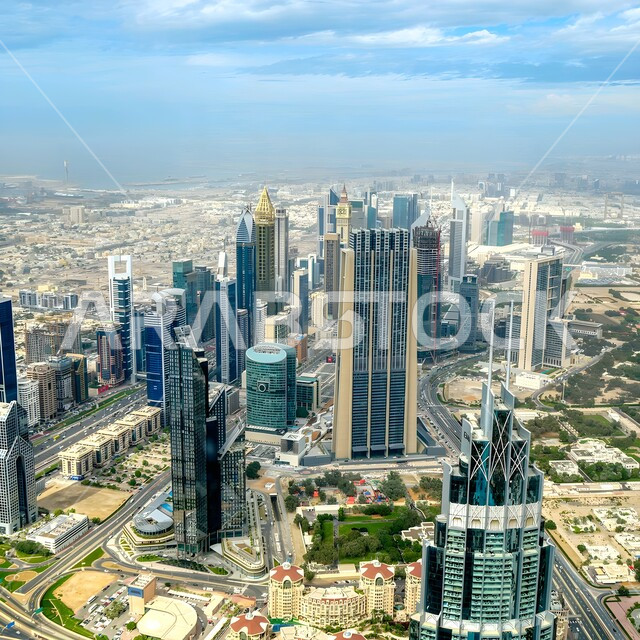 Modern architectural art of commercial buildings and facilities, urban growth and progress, top view of towers and skyscrapers in Dubai, famous tourist attractions in the United Arab Emirates, traffic movement in streets and roads