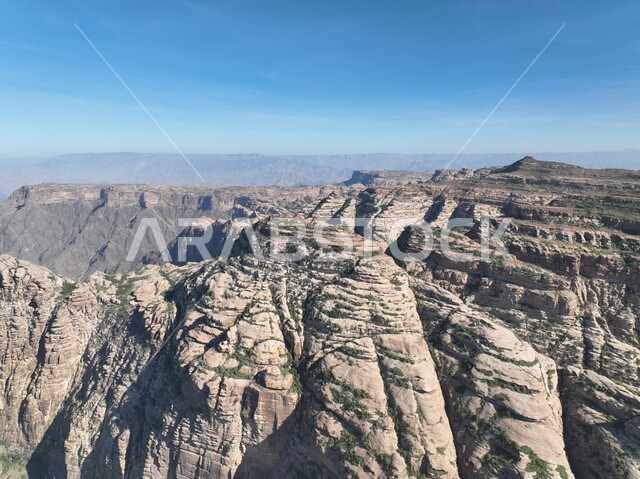 Mountain ranges and heights, rock formations and formations in Jazan city, green plants planted on Al-Qahr Mountains, distinctive natural landscapes, famous tourist places and landmarks in the Kingdom of Saudi Arabia