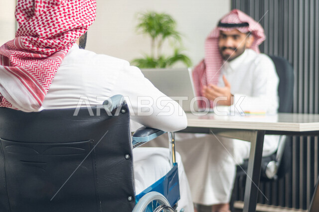 A Saudi Arabian Gulf employee of people of determination working in the workplace, integrating and employing people with disabilities in various fields, social empowerment, interest and support of the Saudi community for people with special