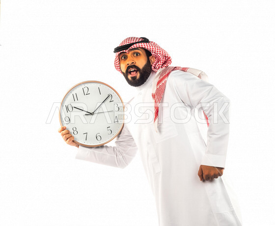 Portrait of a Saudi Gulf man holding a large digital watch with different face and hands gestures, white background of a Saudi man wearing traditional Saudi dress with shemagh and agal, concept of countdown, punctuality, constant reminders and alerts, wor