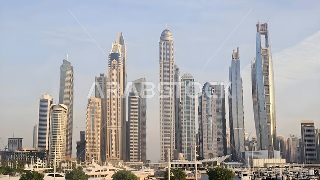 Waterfront on the Arabian Gulf coast, movement of yachts and ships at sea, architectural art of buildings overlooking the harbor, tourist attractions from all over the world, famous tourist places in Dubai, growth and urban expansion of towers and skyscrapers in the United Arab Emirates