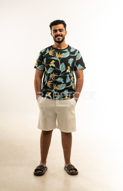 Concern for elegance and appearance, concept of masculinity and self-confidence, taking personal photos for official documents, portrait of a young Arab Gulf Omani man wearing casual clothes looking at the camera with gestures of self-confidence, full-length body photo, white background
