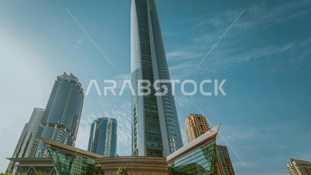 Urban growth and development of towers and skyscrapers, modern architectural art of buildings and facilities in the United Arab Emirates, attracting and attracting tourists from all over the world, a picture from below of the Almas Tower in Dubai during the day