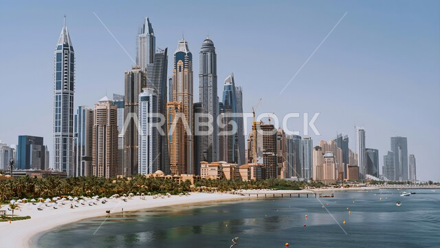 Modern architectural style of towers and skyscrapers overlooking the sea, the tourist destination in the United Arab Emirates, urban growth and development in the Arabian Gulf, attracting and attracting tourists from all over the world
