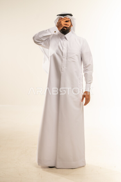 الشعور بالخجل والإحراج، محاولة استراق النظر، البكاء ومشاعر الحزن، إغماض العينين وعدم الرغبة بالرؤية، التعرض لصدمة وعدم التصديق، بورتريه لرجل عربي خليجي قطري يرتدي الثوب التقليدي والغتره يغطي وجهه بيده، الجسم بالطول الكامل، خلفية بيضاء