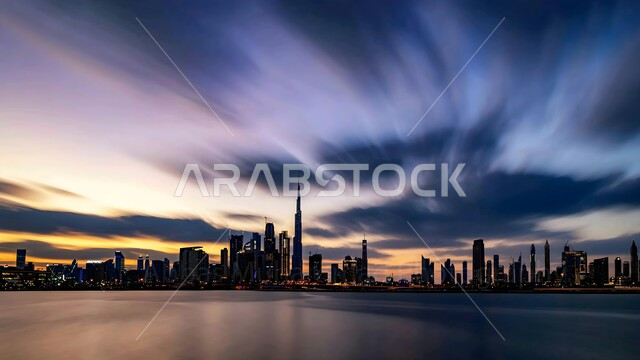 Luxury hotels and resorts overlooking the waterfront at sunset, the growth and urban development of towers and skyscrapers, the touristic coastal landmarks in the UAE, the advanced architectural art of commercial and residential facilities