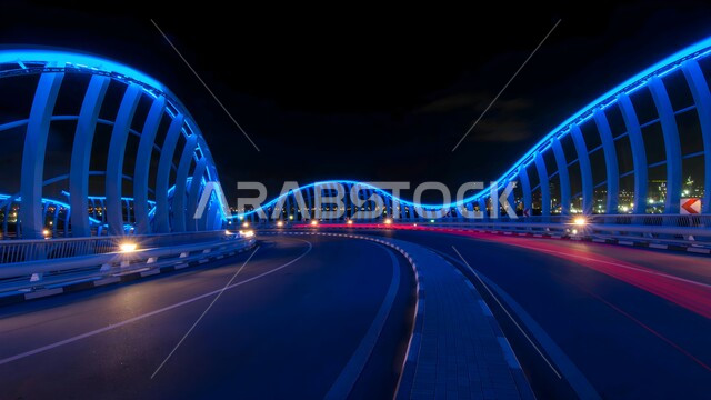 الاهتمام بالبنية التحتية والتقدم العمراني في الإمارات العربية المتحدة، الفن الهندسي المعماري لجسر ميدان دبي المضاء باللون الأزرق في الليل، الجسور والمعالم السياحية المشهورة، جذب واستقطاب السياح من شتى أنحاء العالم