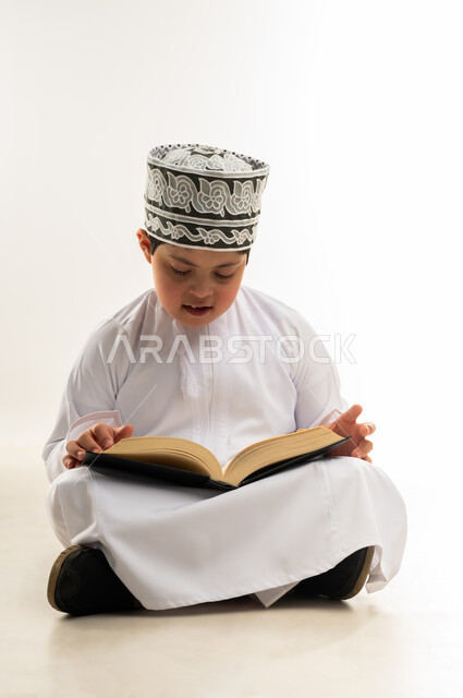 Reading the Book of Allah, memorizing and intonation, gestures of focus and integration, recitation of the Noble Qur’an, the concept of diligence in worship, the way of the life of people of determination white