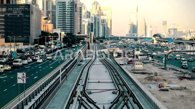 Attention to the infrastructure of bridges and roads, passenger arrival stations, a close-up of the Dubai Metro train, providing facilities and services for those leaving and arriving in the United Arab Emirates, the concept of public transportation, the latest railway systems
