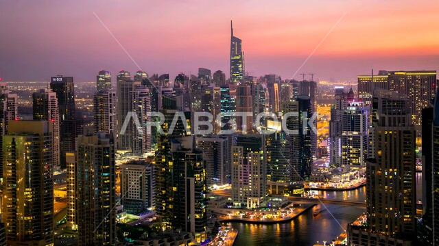 Improving and developing the infrastructure of tourist cities, towers and skyscrapers illuminated at sunset in the United Arab Emirates, urban progress and growth in the Emirate of Dubai, modern architectural arts and designs, building a developed civilized future, high-rise commercial facilities and buildings