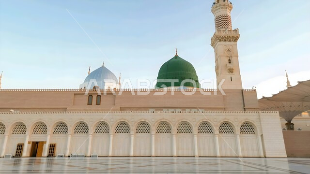 Architectural art of minarets and green dome in Islamic style, Islamic religious holy places, famous mosques in Saudi Arabia, concept of worship and closeness to God, external complex of the Prophet's Mosque in Medina