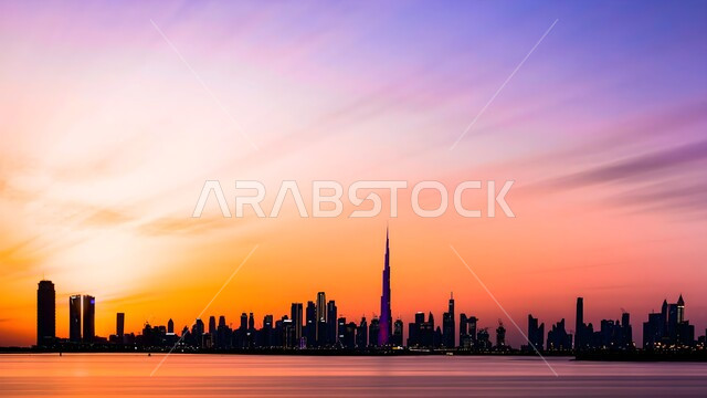 Urban growth and development of Dubai skyscrapers, modern architectural art of building Burj Khalifa, famous landmarks and places in the United Arab Emirates, silhouette of high-rise commercial and residential buildings at sunset, Salulit