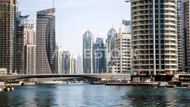 Architectural engineering art of buildings and structures overlooking the sea, Dubai tourist attractions, growth, progress and urban expansion, the waterfront on the coast of the Arabian Gulf, towers and skyscrapers in the United Arab Emirates