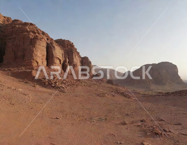 Highlands, mountain peaks and natural slopes, mountain ranges, rock formations and formations in the high peaks in the deserts of the Kingdom of Saudi Arabia, ancient historical archaeological tourist places in the old town of Al-Ula at sunset, soft golden sands, enjoying tourist trips in the desert areas.