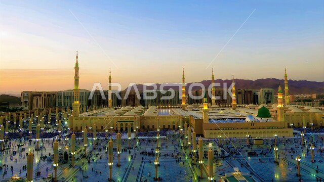 Minarets and domes in the Prophet's Mosque in Medina, the concept of worship, obedience and closeness to God, sacred religious places and landmarks in the Kingdom of Saudi Arabia, the arrival of Muslims from all over the world to the Prophet's Mosque, the architectural art of building mosques in the Islamic style