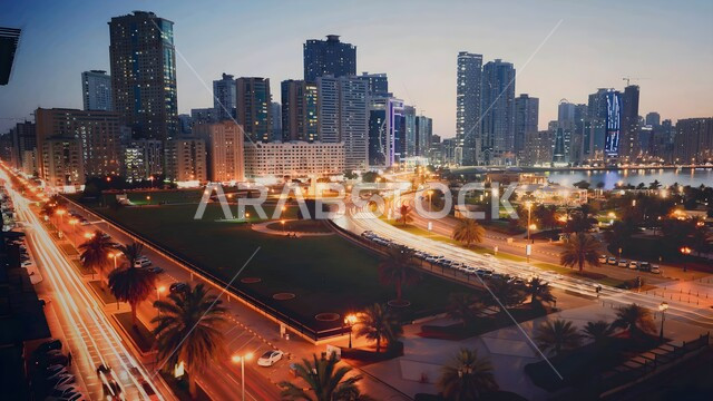 Architectural engineering art of building towers and skyscrapers in Sharjah in modern style, commercial and residential buildings and facilities illuminated at sunset, famous tourist places in the United Arab Emirates, tourist attractions and attractions