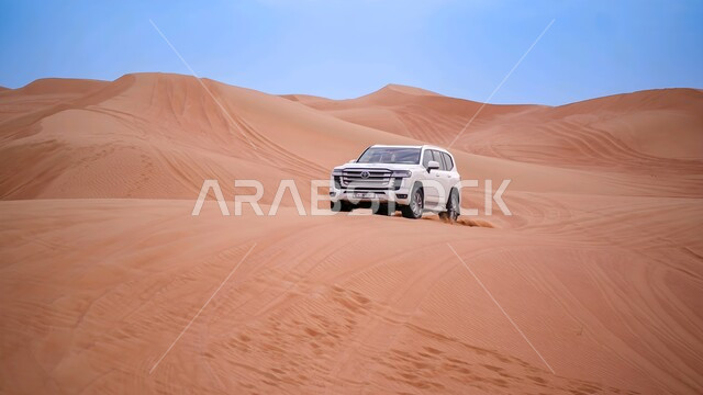  Enjoying fun desert activities and events, exciting adventures on the soft golden sands of the UAE deserts, a white Toyota car driving in the middle of the desert, practicing favorite youth hobbies, safari trips on the sand dunes