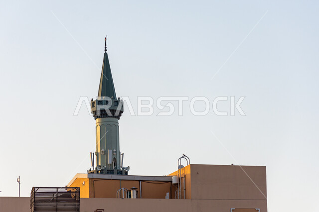 Minaret of a mosque in Bur Dubai, the architectural art of building mosques in the Arab-Islamic style in the United Arab Emirates, the call of Muslims to perform religious duties and prayers, the concept of worship and drawing closer to God