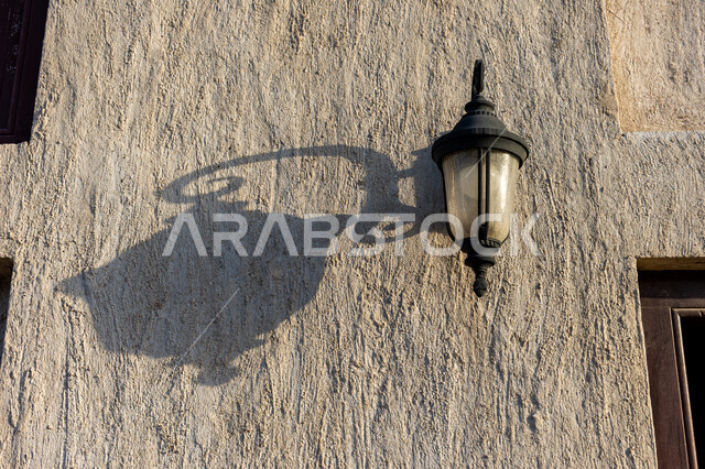 A lantern on the wall of a heritage building in the Shindagha area, historical mud buildings in Dubai, houses and historic buildings in the old traditional style, famous historical tourist attractions in the United Arab Emirates