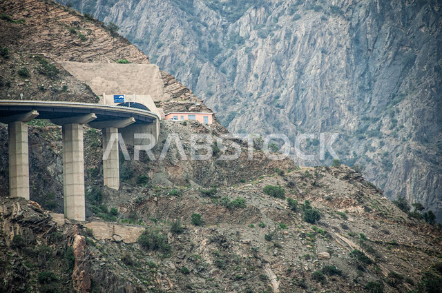 Mountain ranges in the peaks and heights, rugged and winding roads in Al Baha region, tourist areas and spending a fun time, rocky nature in the mountains of the Kingdom of Saudi Arabia, famous tourist attractions during the day