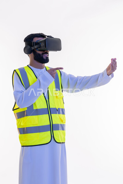 Interacting with virtual engineering, index finger pointing to holographic elements in the palm of the hand, portrait of an Arab Gulf Emirati engineer wearing a kandura, work jacket and virtual reality glasses, future vision 2030, integrating technology with engineering fields, white background