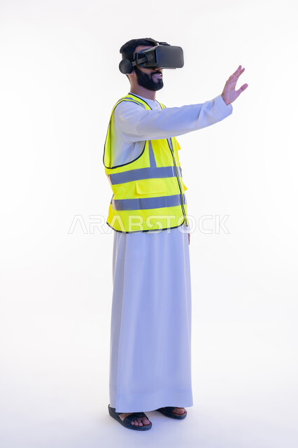 رؤية مستقبلية 2030، رفع كف اليد للمس عناصر هولوجرلمية، التفاعل مع الهندسة الافتراضية، بورتريه لمهندس عربي خليجي إماراتي يرتدي الكندورة والسترة الخاصة بالعمل ونظارة الواقع الافتراضي، دمج التكنولوجيا بالمجالات الهندسية، نمو وتطور المجال الهندسي، خلفية بيضاء