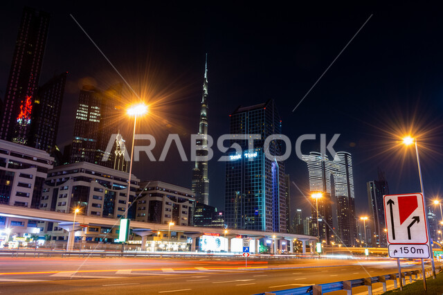 The famous Burj Khalifa illuminated at night, the architectural art of buildings and structures in the United Arab Emirates, the growth and development of towers and skyscrapers on Sheikh Zayed Road, famous tourist places and landmarks, the progress and urban expansion in the Emirate of Dubai