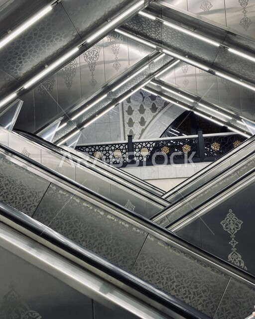 Escalators for easy ascent and descent of pilgrims, sacred Islamic religious places and landmarks, Hajj season in the Kingdom of Saudi Arabia, visiting the Holy House of God in Mecca, worship and drawing closer to the Lord of the Worlds