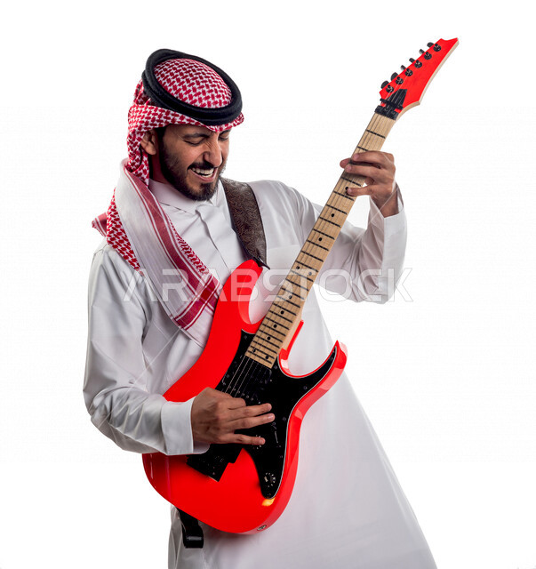 Portrait of a Saudi Arabian Gulf man playing the electric guitar, musical instruments, artistic talents, musical arts.