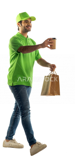 Portrait of a Saudi Arabian Gulf man wearing a green hat working in the delivery of orders and goods to customers, online shopping, online orders, smart shopping, reliable purchase and delivery, delivery representative, fast delivery services for hot drin