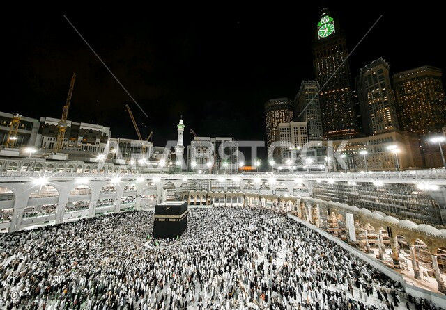 Sacred religious places and landmarks, circumambulating the Kaaba in Mecca, gathering of pilgrims and Umrah performers in the courtyard of the Grand Mosque, performing Hajj and Umrah rituals, the Grand Mosque in the Kingdom of Saudi Arabia, worship and drawing closer to God Almighty, an aerial photo of the Grand Mosque at night