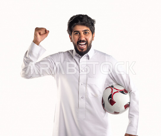 Portrait of a Saudi Arabian Gulf man holding a soccer ball under his ...