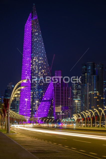 Urban growth and development of towers and skyscrapers, modern architectural art of illuminated buildings and structures at night on the Doha Corniche, tourist attractions and places, the waterfront on the Arabian Gulf coast, Al Mana Tower in Qatar