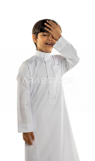 Portrait of a Saudi Gulf boy putting his hand on his head, feeling shocked and failed, different facial and hand gestures, white background