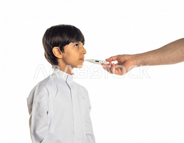 Hand portrait of a Saudi Arabian Gulf man putting a thermometer to check the temperature of a Saudi Arabian Gulf boy, facial expressions indicating illness and fatigue, white background