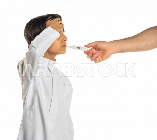 Hand portrait of a Saudi Arabian Gulf man putting a thermometer to check the temperature of a Saudi Arabian Gulf boy, facial expressions indicating illness and fatigue, white background
